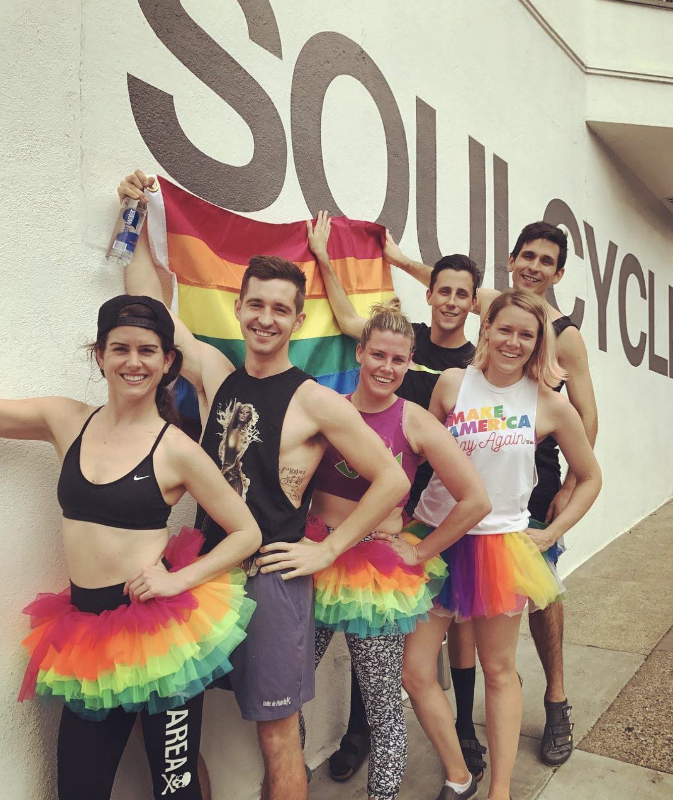 Riders in rainbow tutus outside SoulCycle for a wayOUT ride