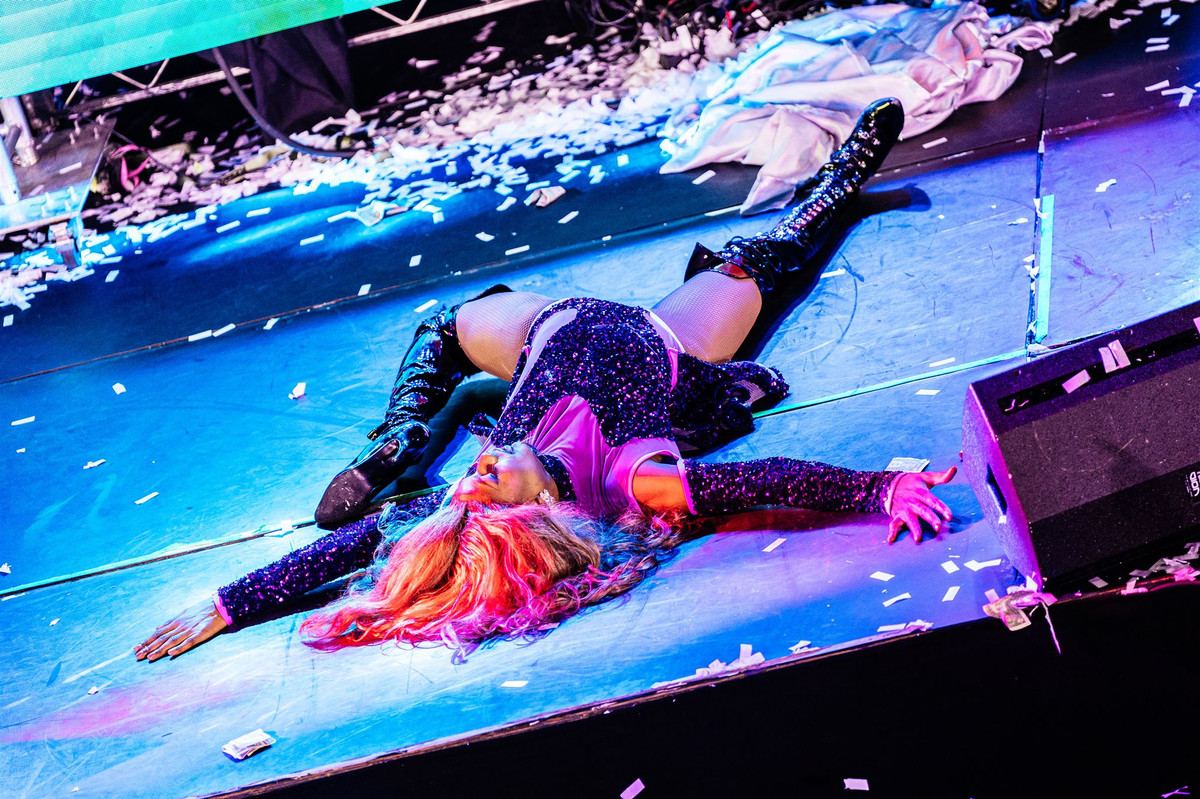 A performer on stage in a shower of confetti at a wayOUT Gayla