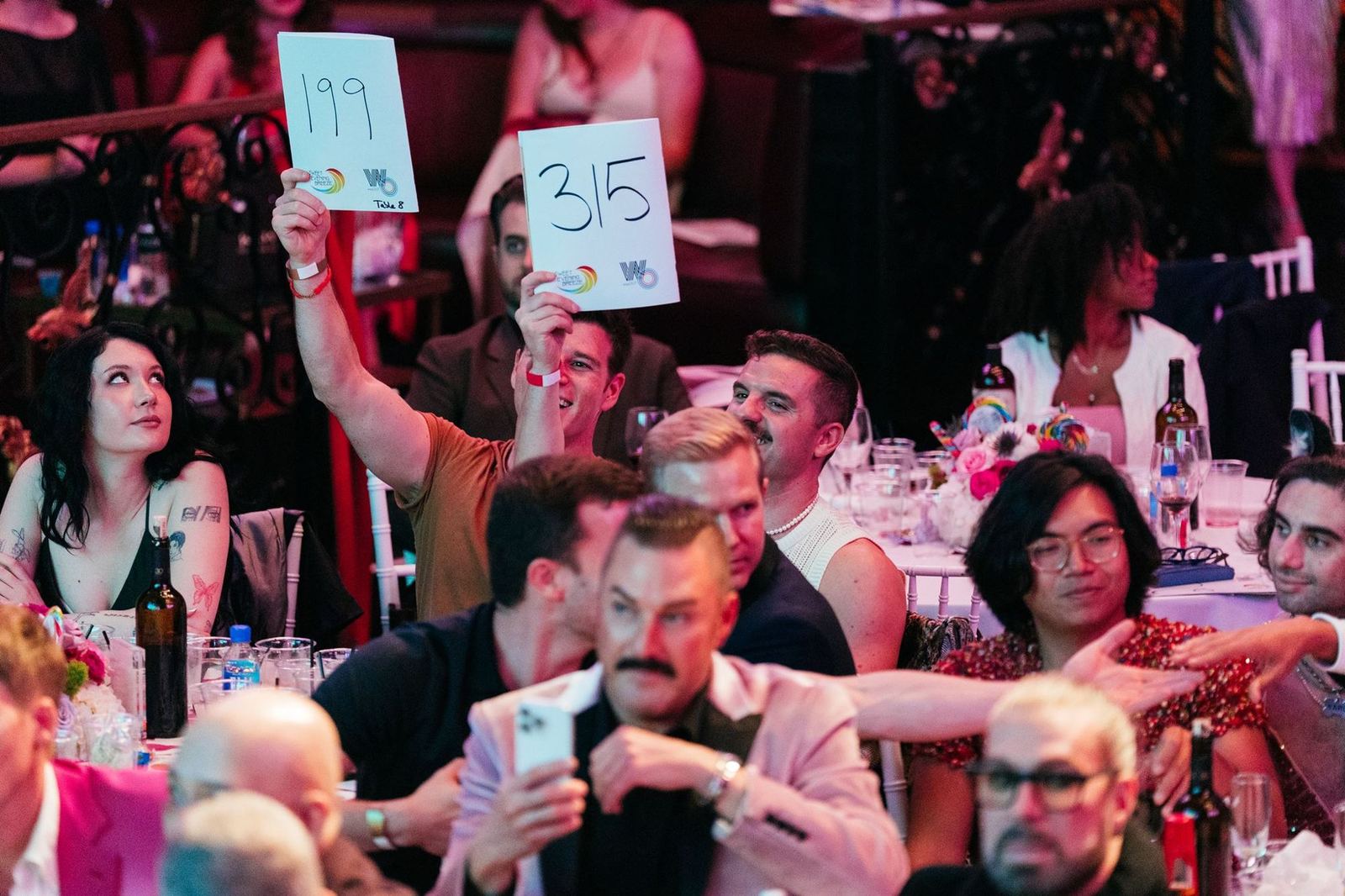 Guests raise bid paddles during the live auction at the 2025 LA Gayla