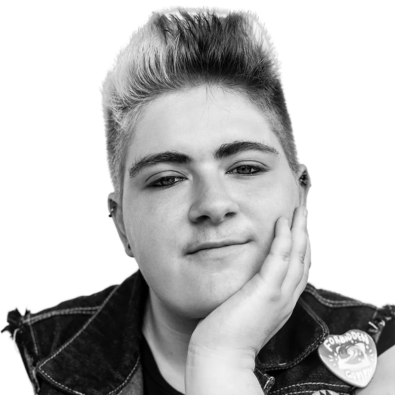 Youth from OUTMemphis with a blond quiff, chin in hand